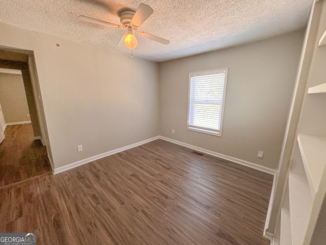 unfurnished bedroom featuring a textured ceiling, dark wood-type flooring, and ceiling fan