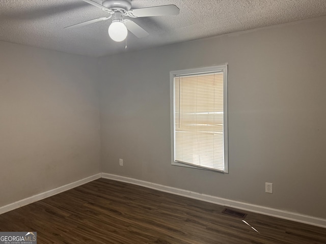 unfurnished room with ceiling fan, dark hardwood / wood-style floors, and a textured ceiling