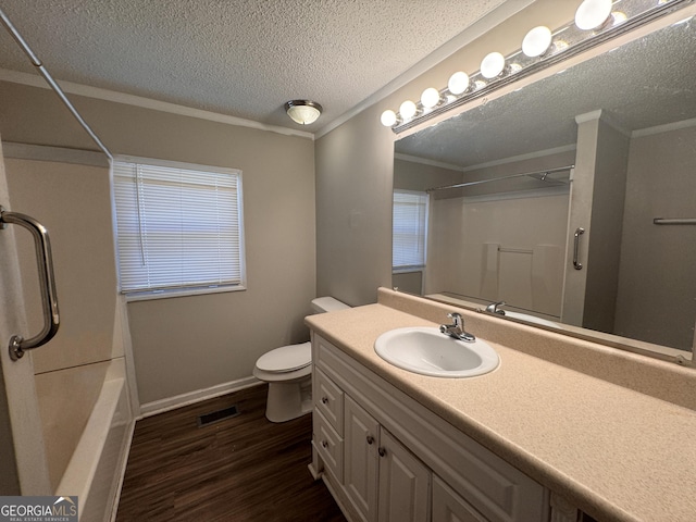 bathroom featuring crown molding, hardwood / wood-style floors, vanity, a textured ceiling, and toilet