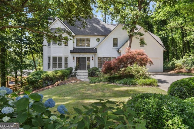 view of front of house featuring a front lawn and a garage