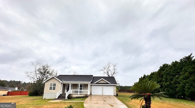 ranch-style house featuring a porch, a garage, and a front lawn