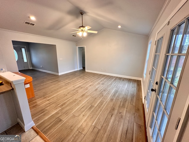 unfurnished living room with ceiling fan, hardwood / wood-style floors, and ornamental molding