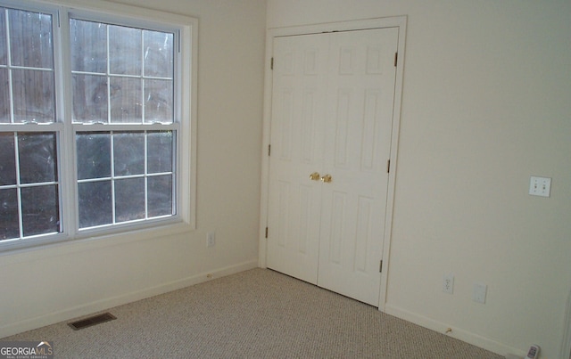 interior space featuring a closet and carpet