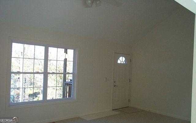 carpeted entrance foyer with plenty of natural light and lofted ceiling