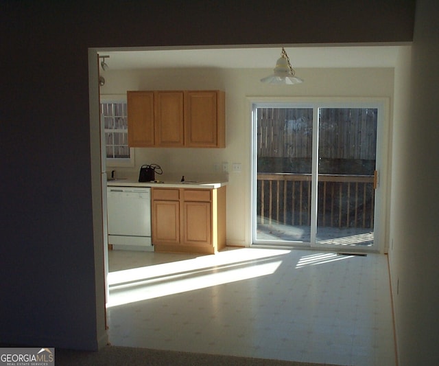 kitchen with white dishwasher and tile flooring