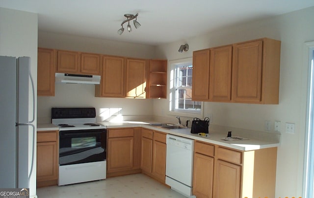 kitchen featuring sink, white appliances, and light tile floors