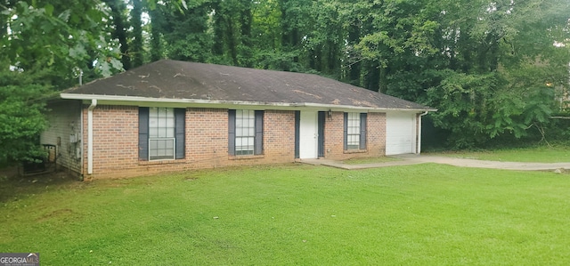 view of front of property with a front lawn and a garage