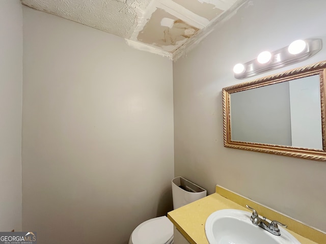 unfurnished bedroom featuring a closet, ceiling fan, hardwood / wood-style floors, and a textured ceiling