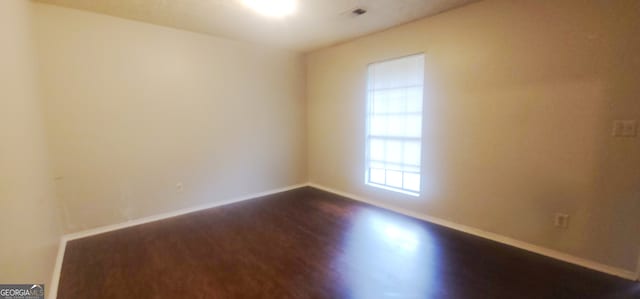 entrance foyer with a textured ceiling and dark hardwood / wood-style floors