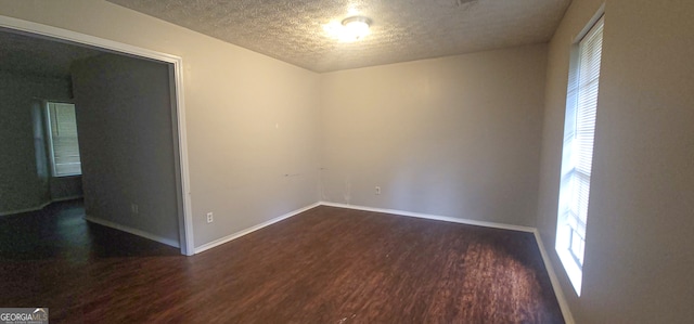 unfurnished room featuring dark hardwood / wood-style flooring