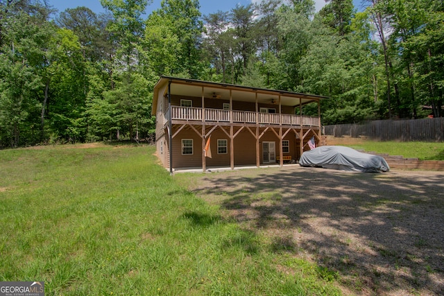 rear view of property featuring a lawn