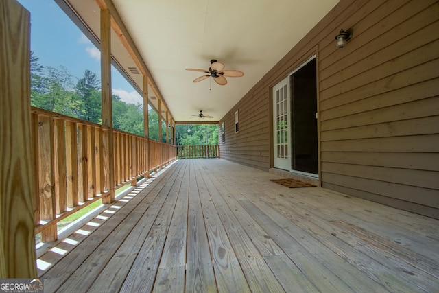 wooden deck featuring ceiling fan