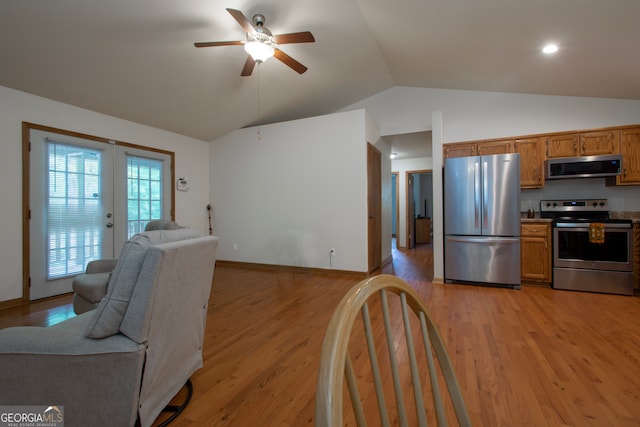 kitchen with ceiling fan, french doors, stainless steel appliances, vaulted ceiling, and light wood-type flooring