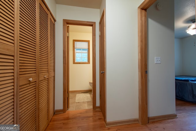 hall with hardwood / wood-style flooring