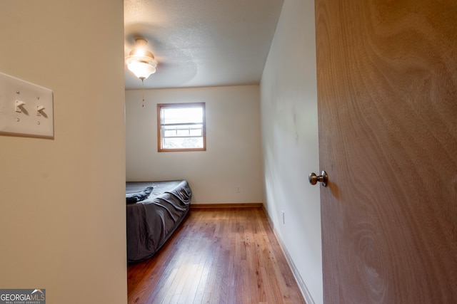 bedroom with ceiling fan and hardwood / wood-style floors