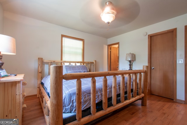 bedroom with ceiling fan and hardwood / wood-style flooring