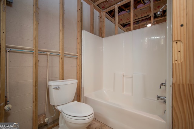 bathroom featuring washtub / shower combination and toilet