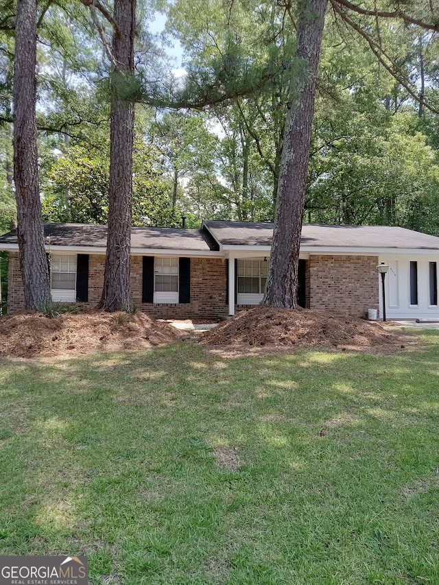 ranch-style house with a front lawn