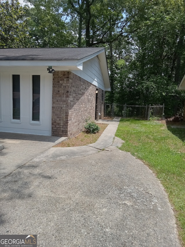 view of side of home featuring a yard