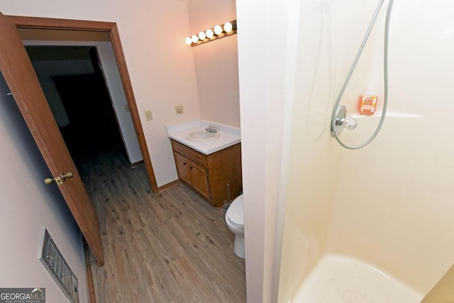 bathroom featuring hardwood / wood-style flooring, vanity, and toilet