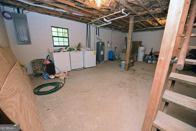 basement with electric water heater and washer and clothes dryer