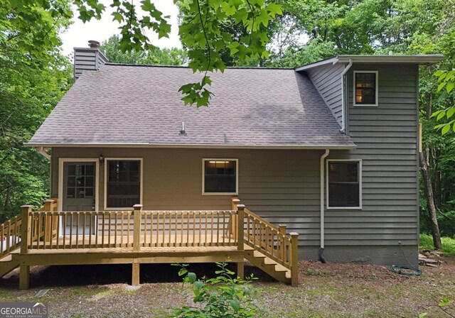 back of property with a wooden deck