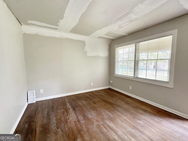 unfurnished room featuring hardwood / wood-style flooring