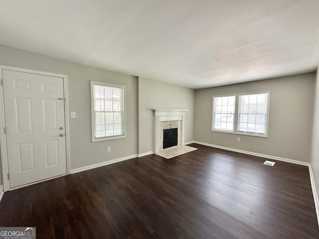 unfurnished living room featuring dark hardwood / wood-style flooring