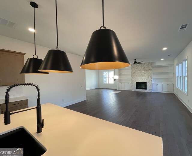 living room featuring wood-type flooring and a stone fireplace