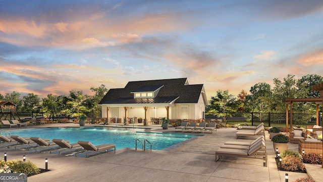 pool at dusk featuring a patio