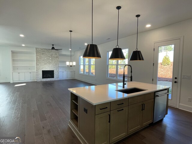 kitchen featuring stainless steel appliances, light hardwood / wood-style flooring, tasteful backsplash, and a kitchen island with sink