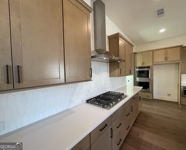 kitchen featuring white cabinetry, hanging light fixtures, a breakfast bar area, backsplash, and stainless steel gas cooktop