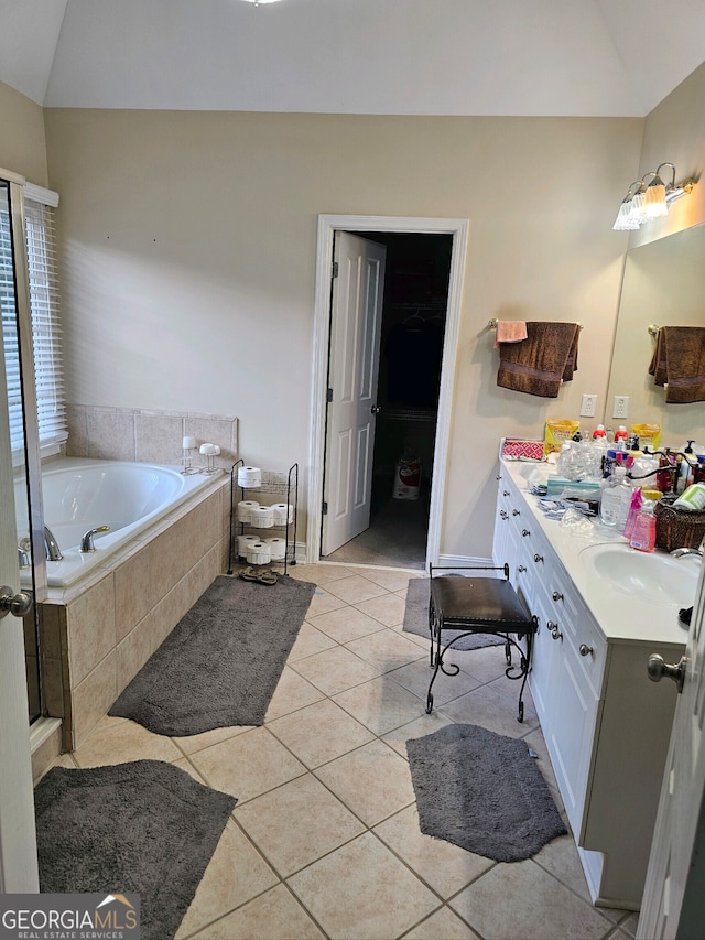 bathroom featuring tile patterned floors, vanity, plus walk in shower, and lofted ceiling