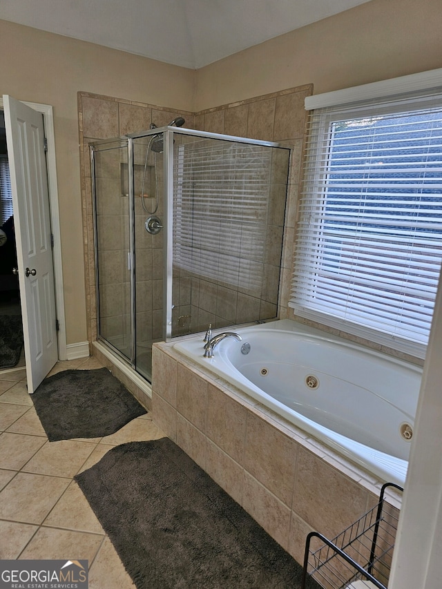 bathroom with tile patterned flooring and separate shower and tub