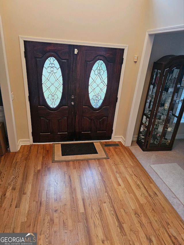 entryway featuring wood finished floors and baseboards