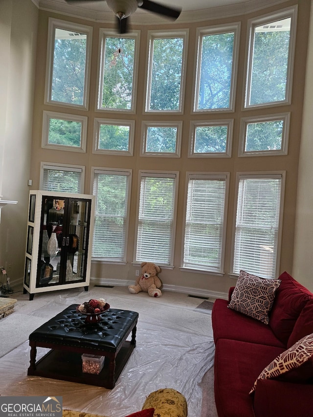 carpeted living room with ceiling fan