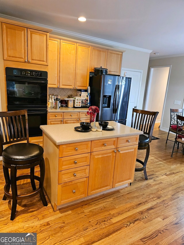 kitchen with double oven, ornamental molding, stainless steel fridge, light hardwood / wood-style flooring, and decorative backsplash