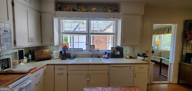 kitchen with sink, tile countertops, white appliances, and backsplash