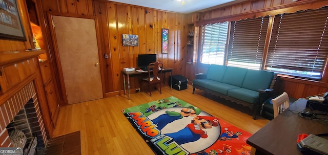 living room with wood walls and hardwood / wood-style floors