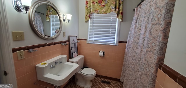 bathroom featuring tile floors, tasteful backsplash, toilet, and tile walls