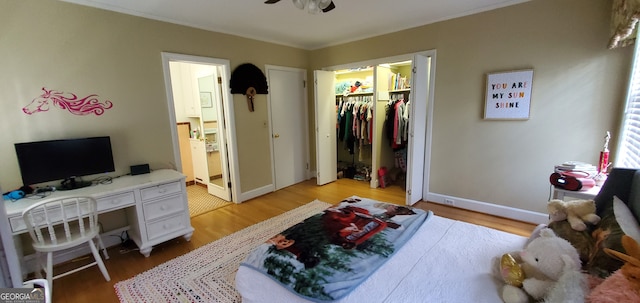 bedroom with a spacious closet, hardwood / wood-style flooring, and a closet