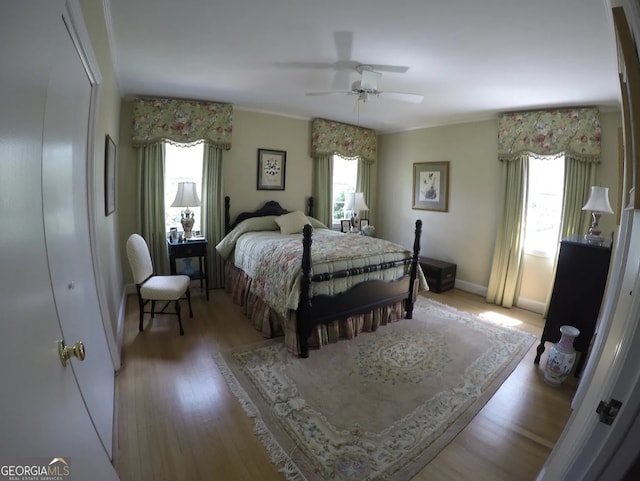 bedroom featuring hardwood / wood-style floors, a closet, and ceiling fan