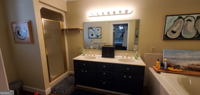 bathroom featuring separate shower and tub and dual bowl vanity