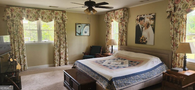 bedroom with crown molding, carpet flooring, multiple windows, and ceiling fan