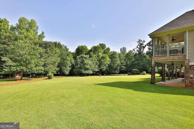 view of yard with ceiling fan and a patio area