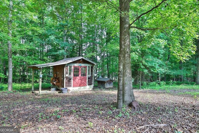 view of shed featuring a view of trees