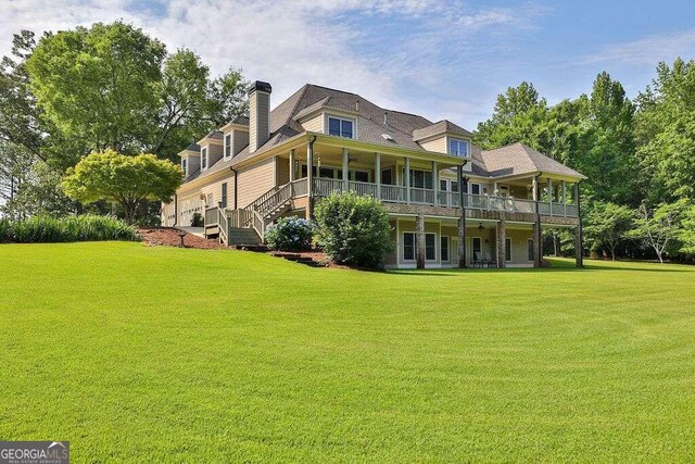 rear view of property with a lawn