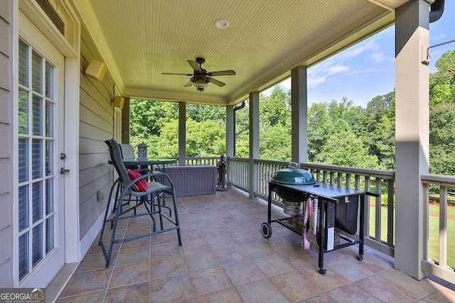 sunroom / solarium featuring a ceiling fan and plenty of natural light