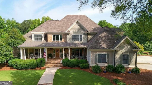view of front facade with covered porch and a front yard