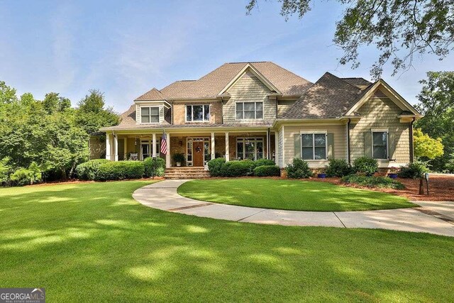 view of front of house featuring a front yard and covered porch